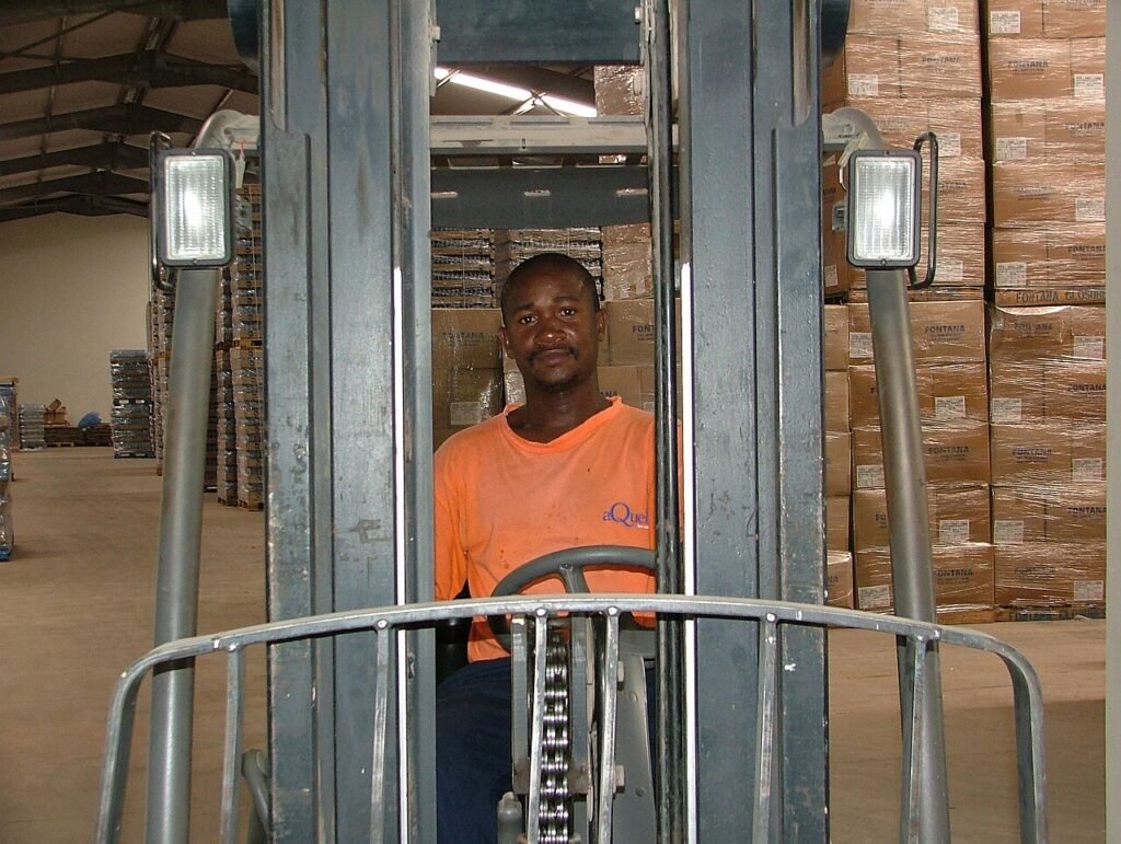 Forklift operator working inside a distribution warehouse